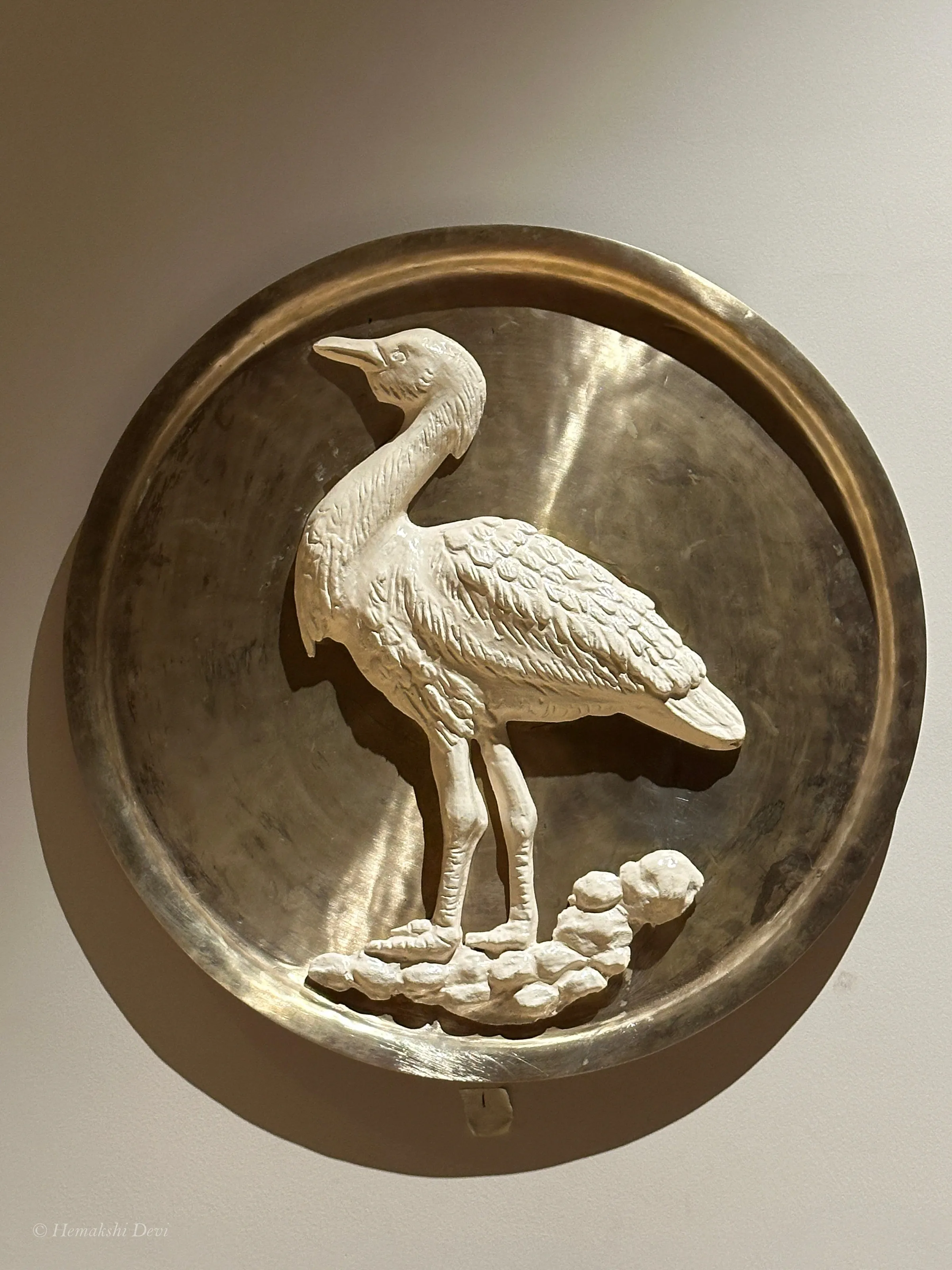 Detail of a bell-metal medallion with a Kaziranga bird relief